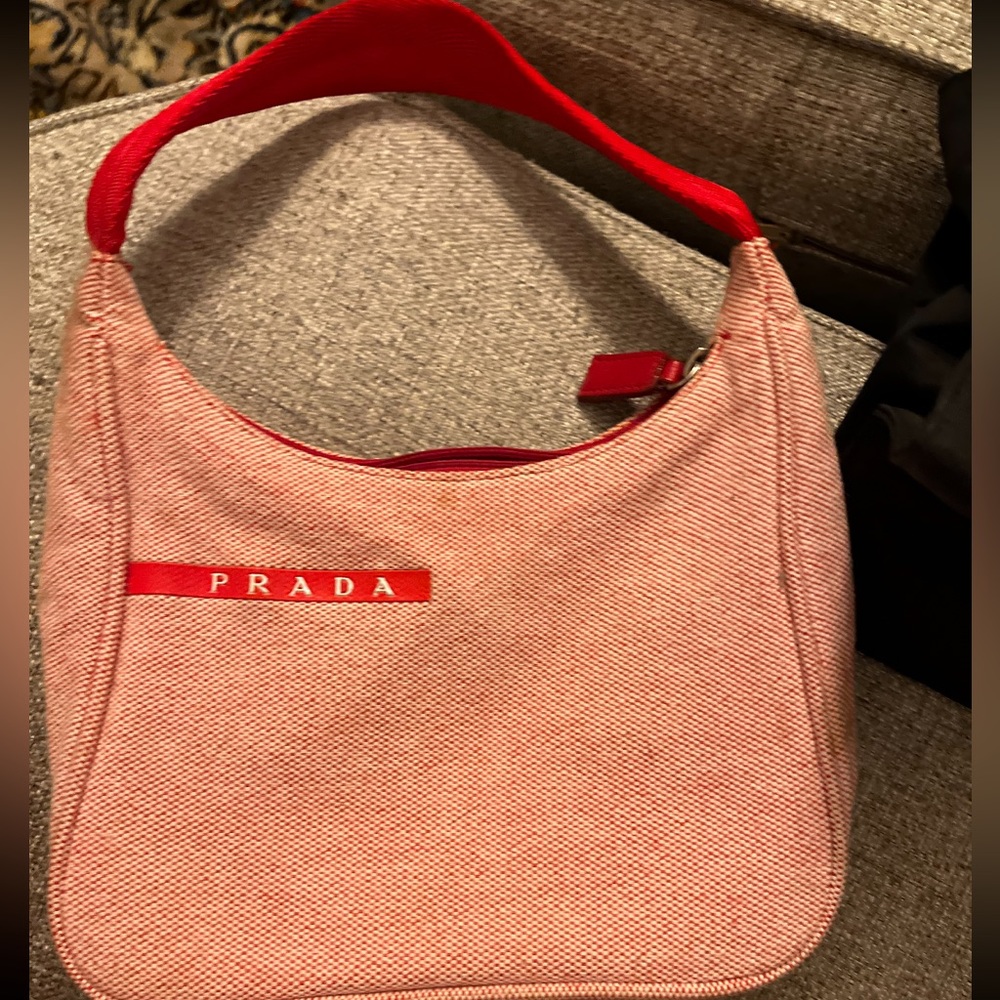 - Prada bag
Several small stains on bag.
